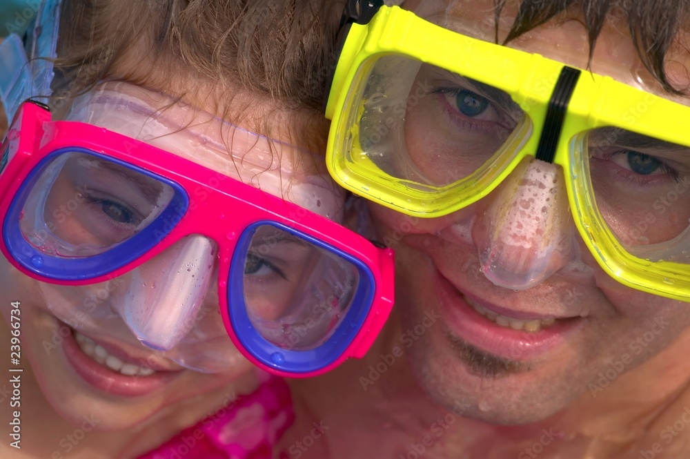 Father and daughter with swimming masks Father and daughter with swimming masks