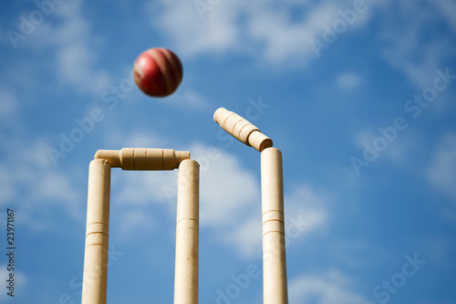 Cricket stumps and bails hit by a ball photo