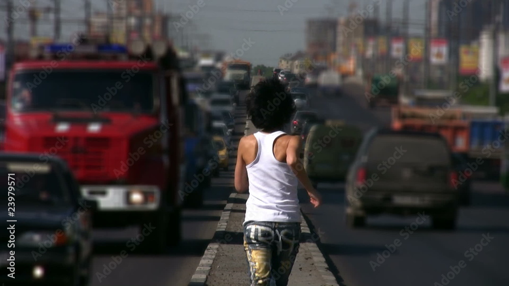 girl runs from camera on highway middle in city girl runs from camera on highway middle in city