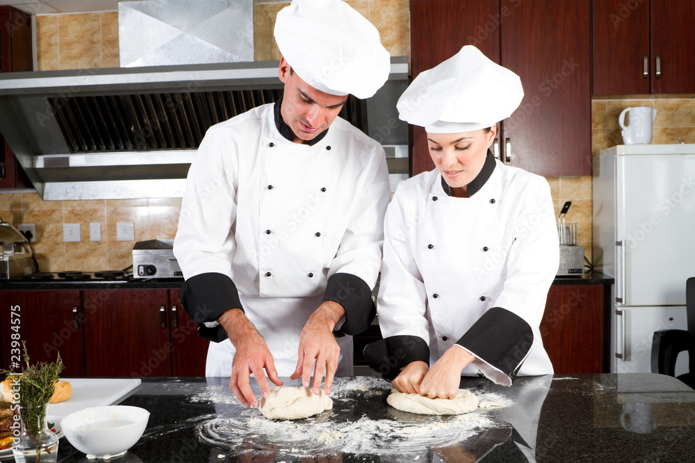 professional chefs hands kneading bread dough on a cutting board professional chefs hands kneading bread dough on a cutting board