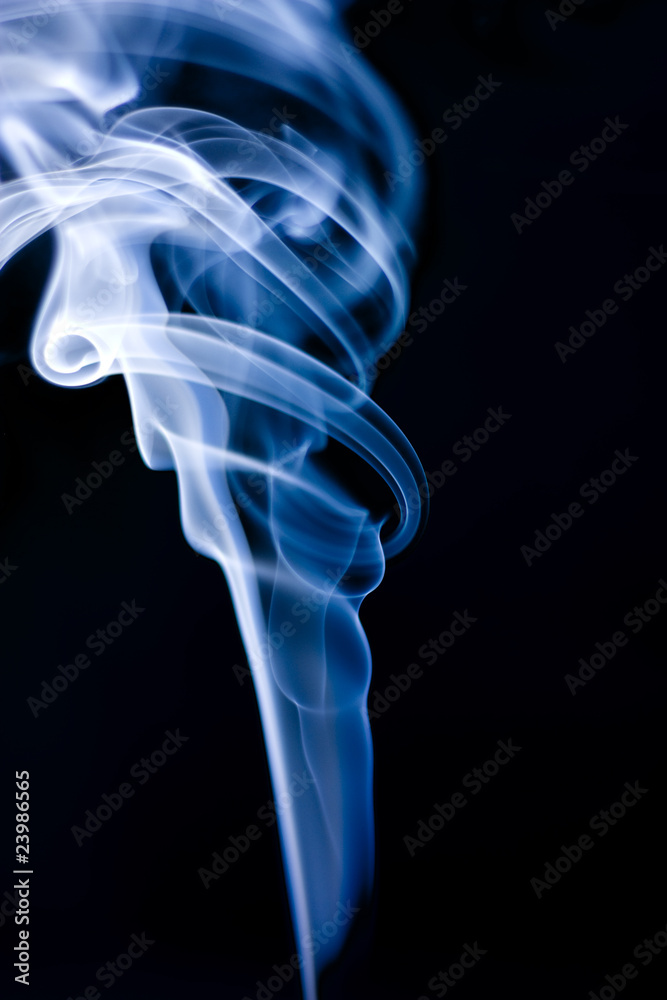 Fototapeta premium Stream of a blue smoke on a black background