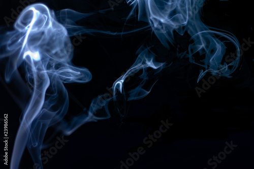 Stream of a blue smoke on a black background