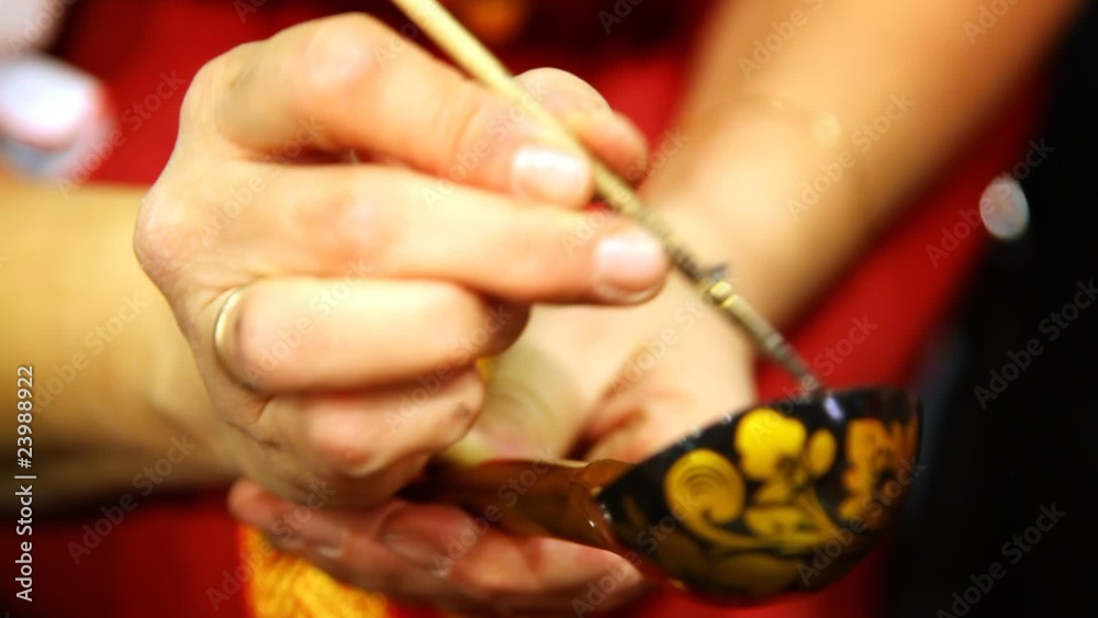 female hands holding wooden spoon and painting it female hands holding wooden spoon and painting it