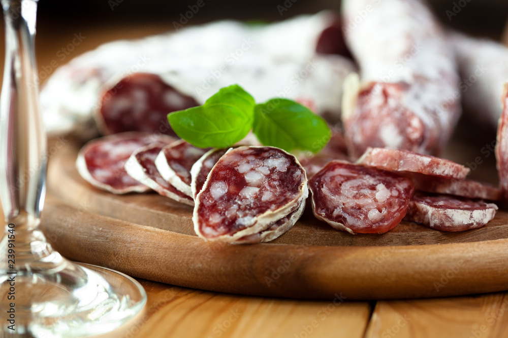 French dried sausage on rustic wooden table French dried sausage on rustic wooden table