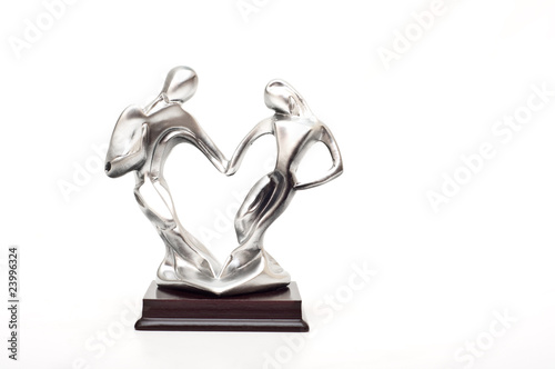 silver figurine shaping a heart isolated on white background