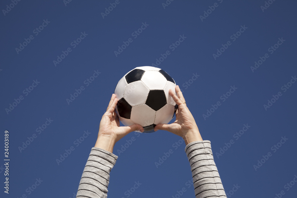 Hands holding a soccer ball