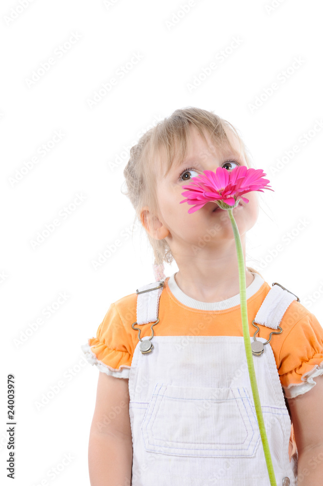 girl sniffs a flower.