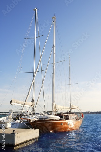 beautiful wooden sailboat on blue sea