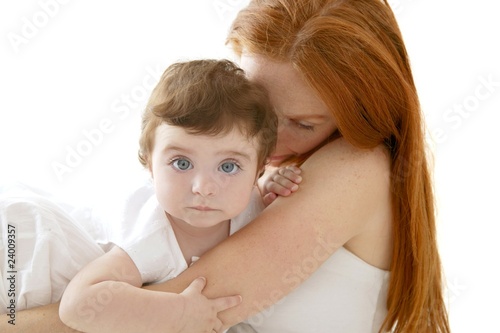 baby and redhead mother hug on white