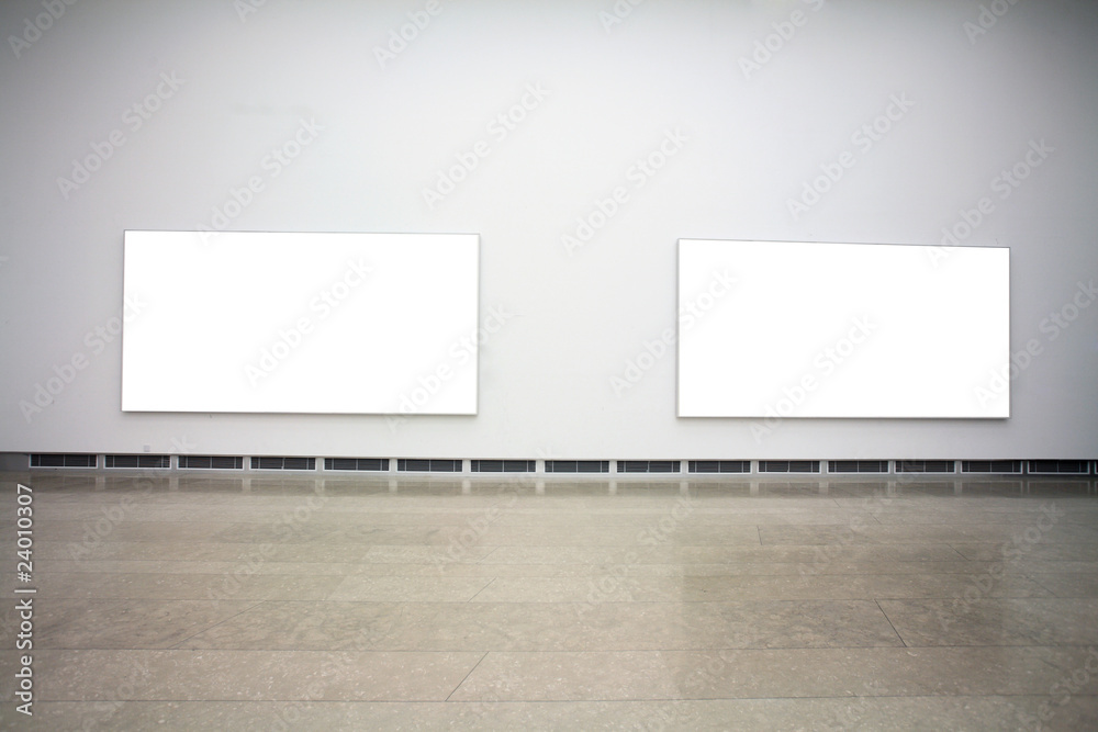 empty frames in a room against a white wall . empty frames in a room against a white wall .
