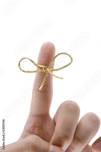 remember concept,  finger with gold tie photo