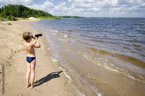 young man looks in the binocular