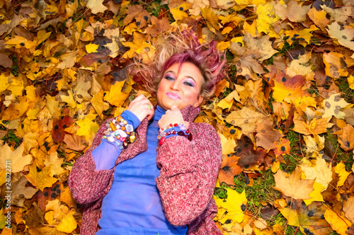 young smiling woman on maple leaves