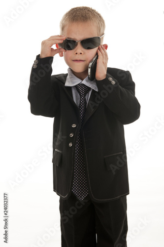 A small boy pretending to be a businessman.