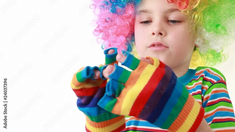 Boy in ridiculous wig wears gaudy striped gloves Boy in ridiculous wig wears gaudy striped gloves