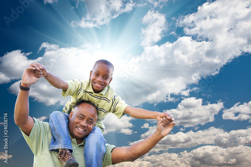 Bild auf Leinwand Happy African American Man with Child Over Clouds and Sky