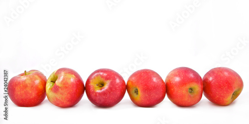 six red apples in a row isolated on white background