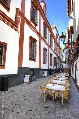 Cobbled street with pavement restaurant in Seville