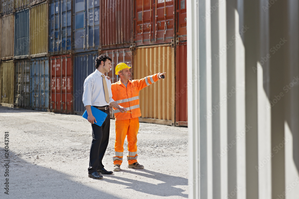 businessman and manual worker with cargo containers businessman and manual worker with cargo containers
