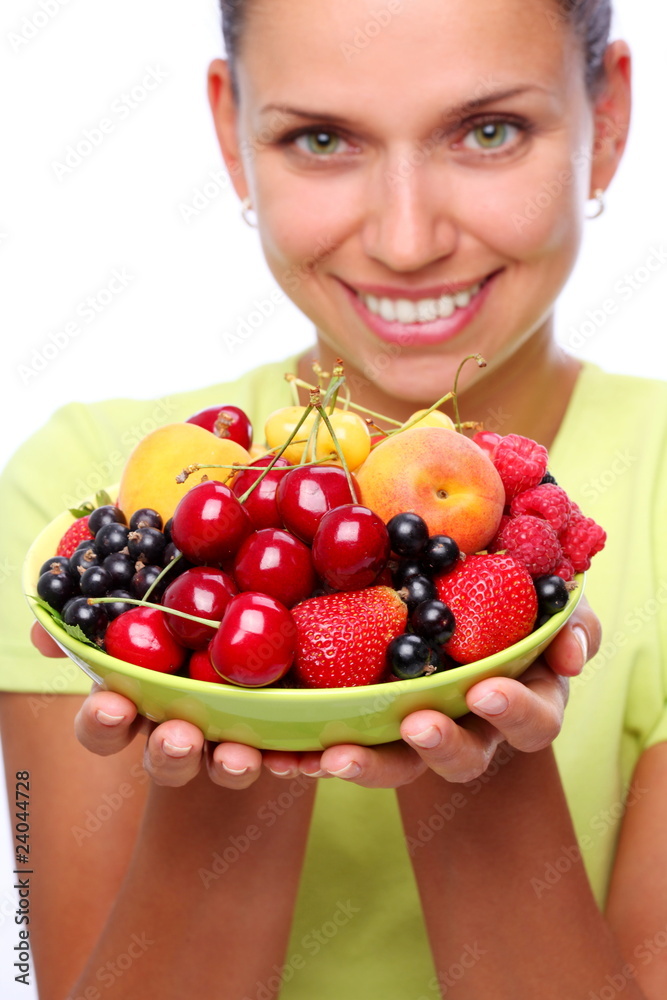 Smiling young woman keep full plate of berries. Smiling young woman keep full plate of berries.