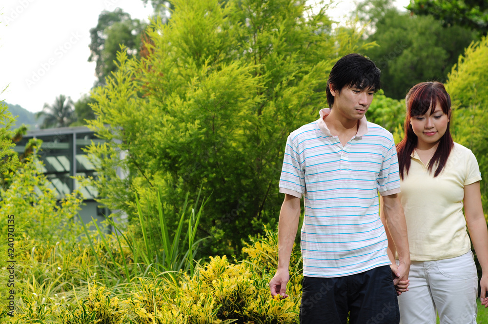 Young Asian Couple in Love walking through the park 2 Young Asian Couple in Love walking through the park 2