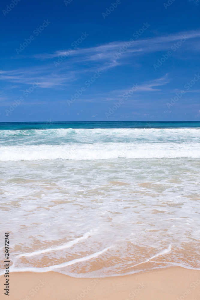 Beautiful beach with crashing waves in the tropics Beautiful beach with crashing waves in the tropics