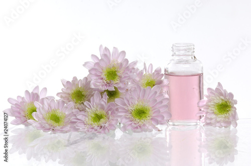 spa bottles and daisies with reflection