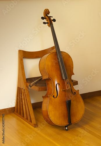 Cello or violincello, resting on chair with bow
