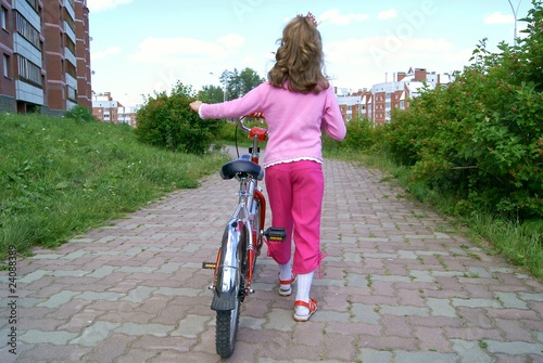 Fototapeta Naklejka Na Ścianę i Meble -  The girl with a bicycle