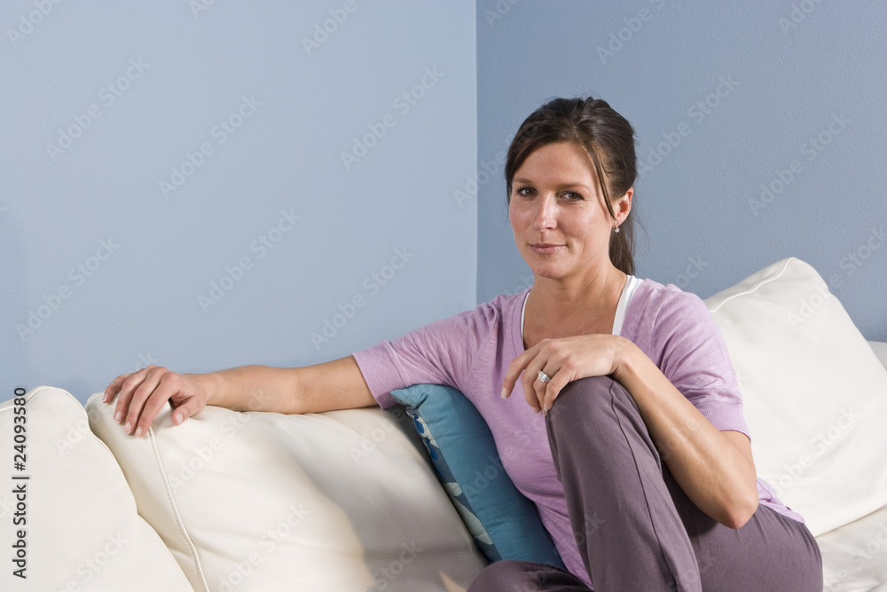 Fototapeta premium Portrait of woman sitting on couch at home