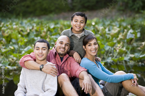 Portrait of Hispanic family with two boys outdoors