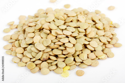 Lentil scattered on white background close up view