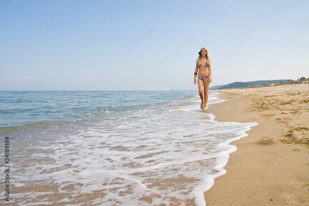 Beauty woman walking on tropical beach
