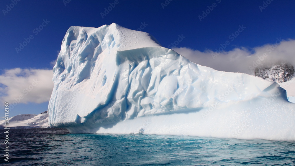 Magnificent iceberg in Antarctica in azure waters on a sunny day