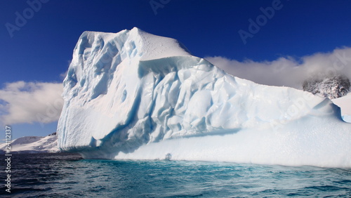 Magnificent iceberg in Antarctica in azure waters on a sunny day © Achim Baqué