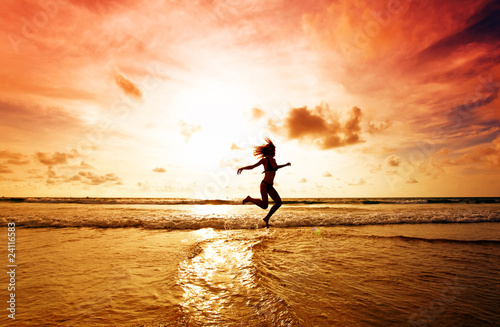 The girl jumping on a tropical beach