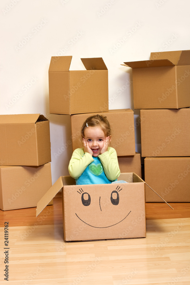 Little girl in cardboard box - moving concept