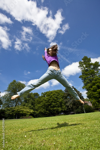 young girl dancing happy in a park