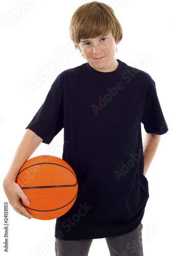 Young boy holding a basketball isolated over a white background