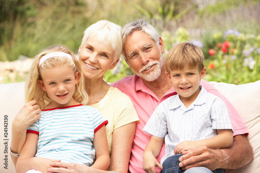Fototapeta premium Grandparents And Grandchildren Relaxing In Garden