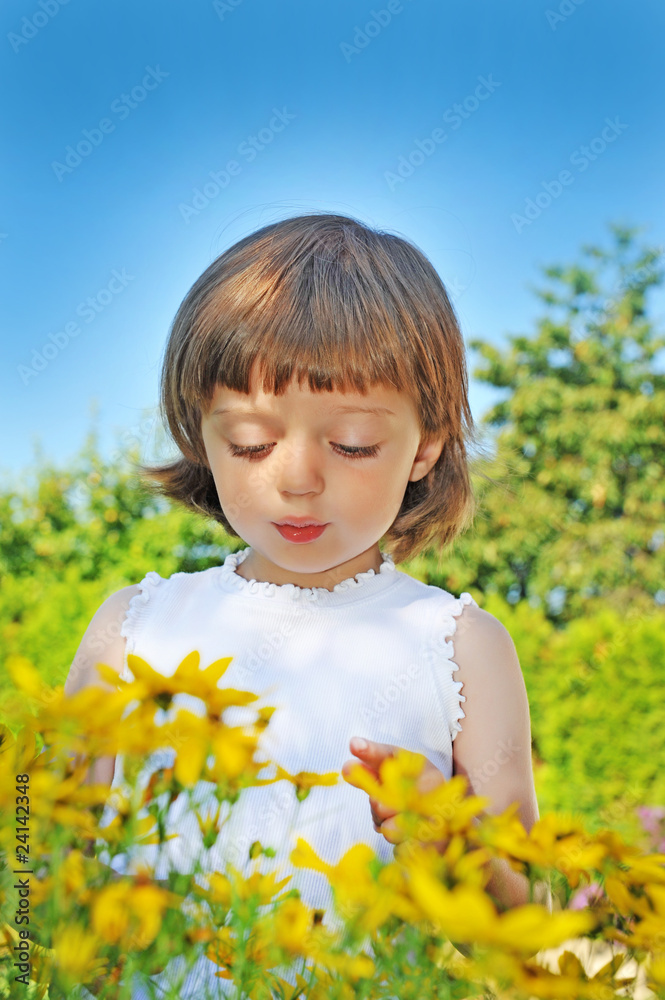 little girl (3 years old) with flowers in garden little girl (3 years old) with flowers in garden