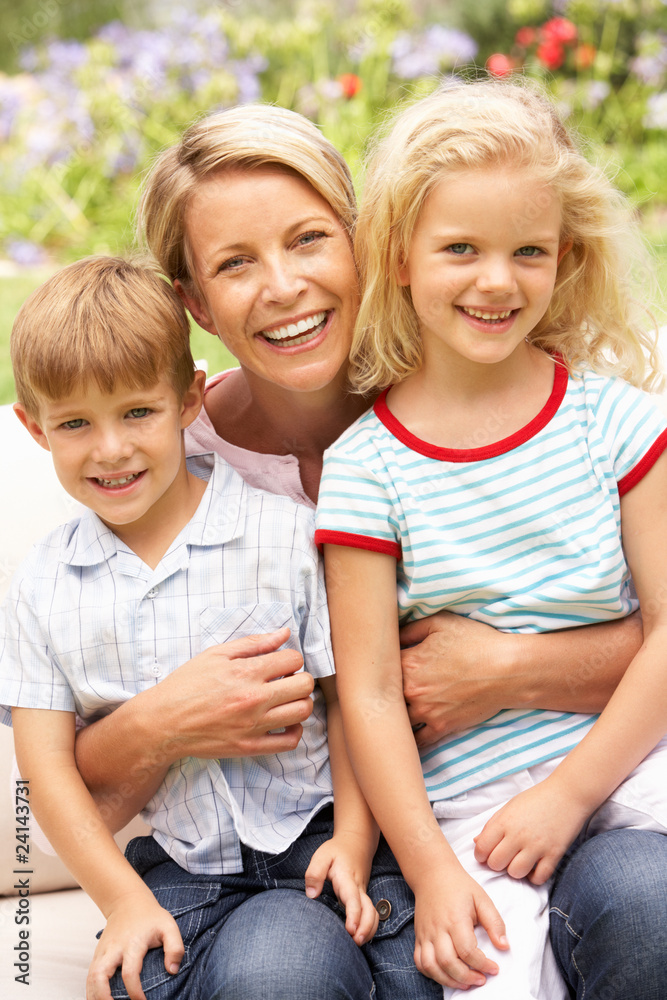 Fototapeta premium Mother And Children Relaxing In Garden