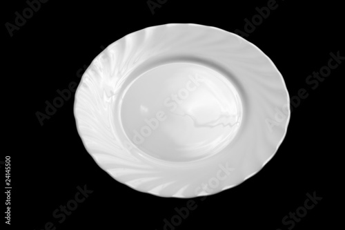 Round white plate isolated on black background