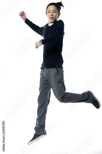 Young man jumping on white