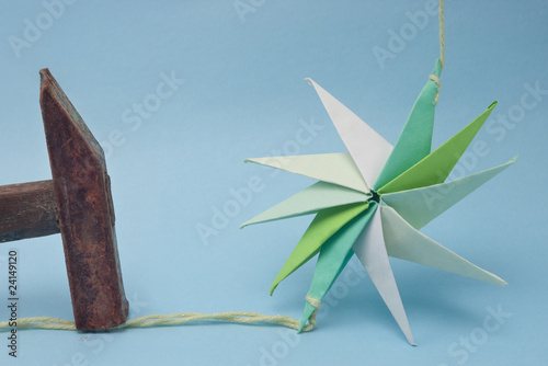 star shaped paper origami nailed by rusty hammer