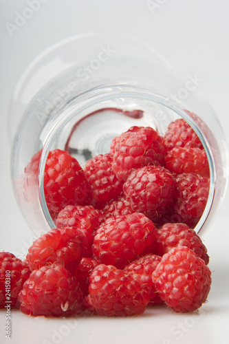 raspberries spilled from a glass