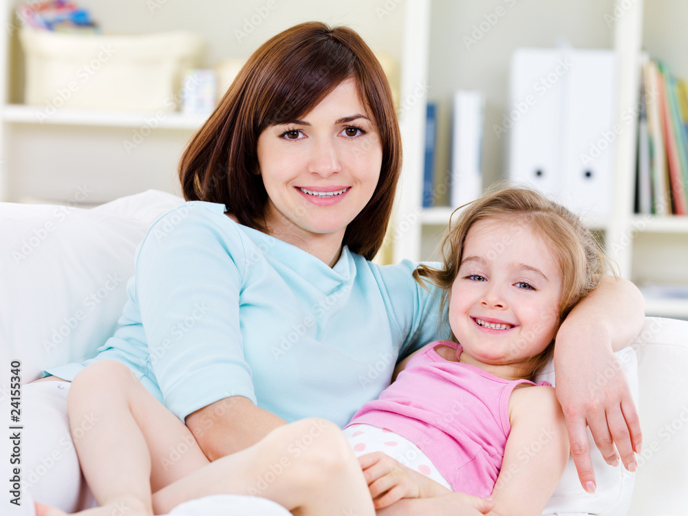 Woman with daughter relaxing at home Woman with daughter relaxing at home