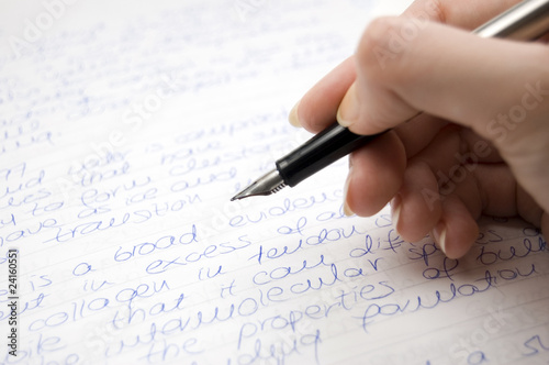 female hand holding pen, writing