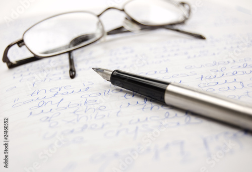 Pen and glasses on a notebook