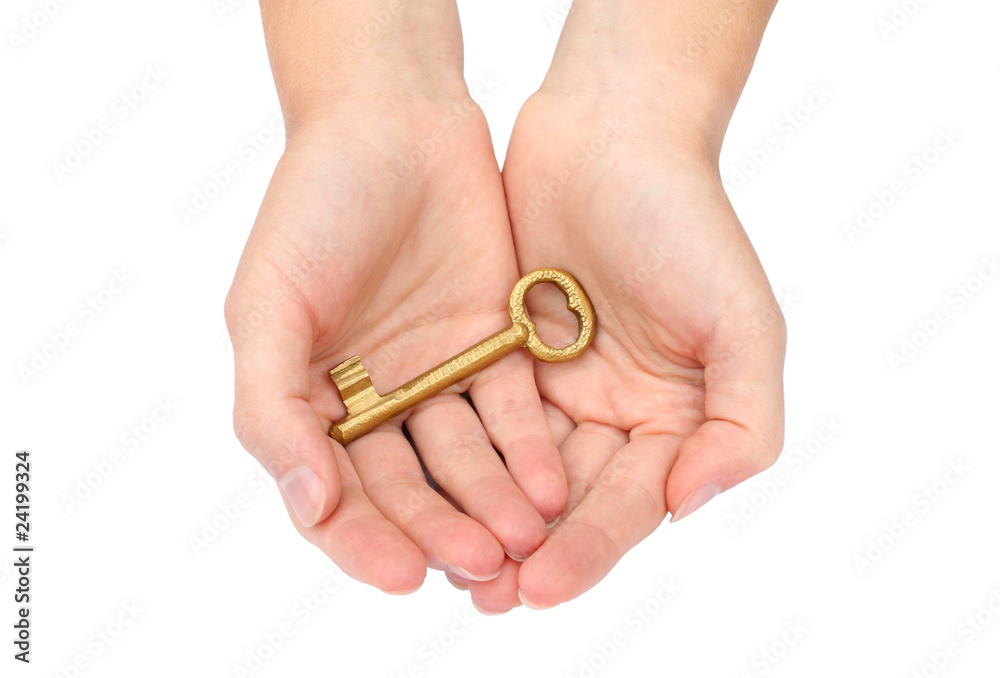 Hand holding a gold key
